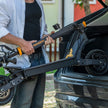 Person loading a black electric scooter onto a car trunk L1_Ausom_Scooter_Folded_in_car_easy_tansport