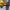 Person holding a folded electric scooter with a blurred background L1_Electric_scooter_Folded_carring_by_person