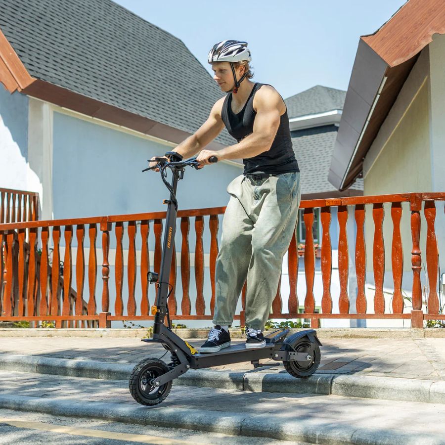 Person riding an electric scooter on a rooftop with a clear sky Person_riding_the_L1_Ausom_Electric_scooter_2