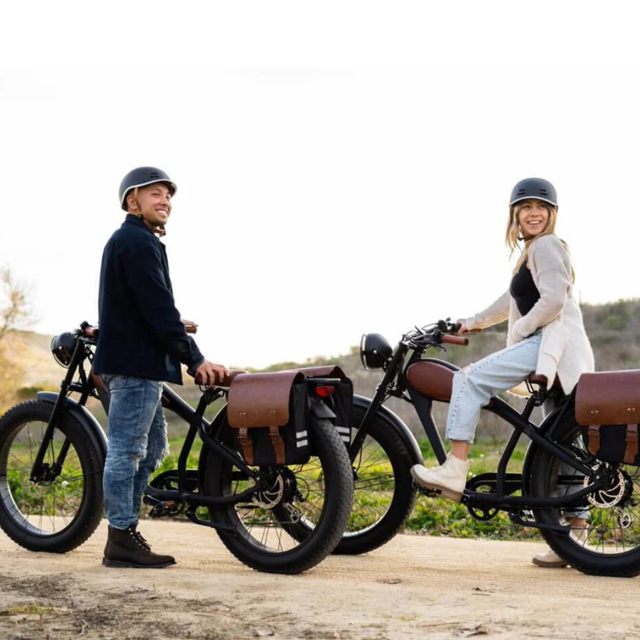 Two people standing next to electric bikes in a natural setting Cheetah Pro Sale Revi Ebike