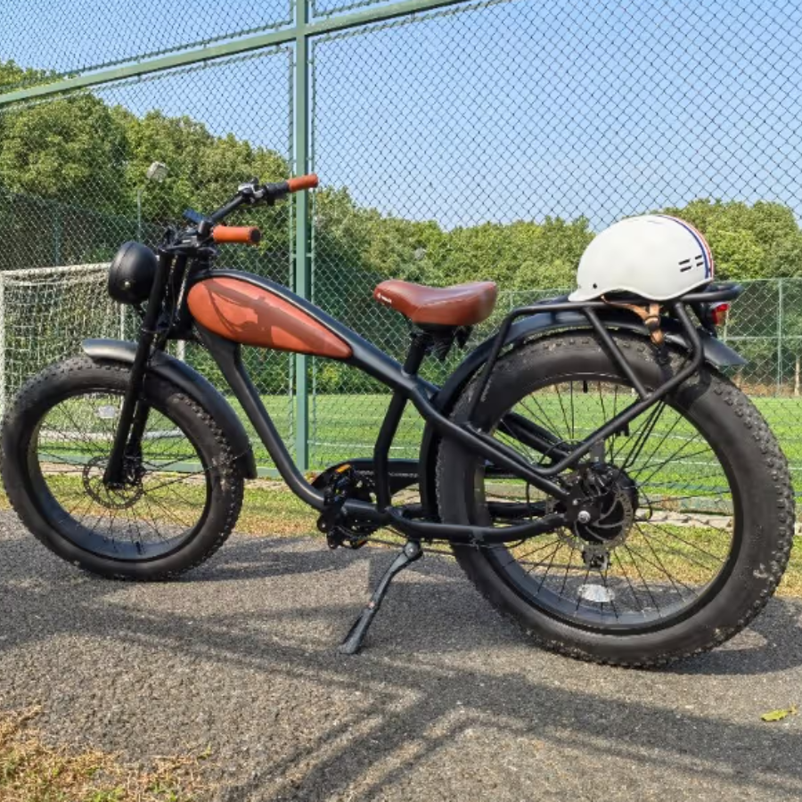 Black electric bike with brown seat and white helmet on a paved path with greenery in the background Cheetah Pro Sale Revi Ebike