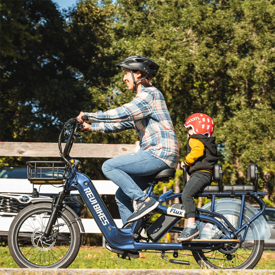 Family with the Revi Flux cargo electric bike outdoors