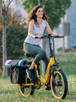 Woman riding the Revi Rebel 2 folding e-bike with loaded rear saddle bags