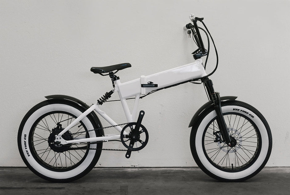 Vee Tire Co. E-Speedster white wall fat tires on a moped-style electric bike, drive-side view